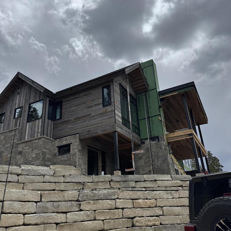 Gutters and heat tape installation on custom home exterior