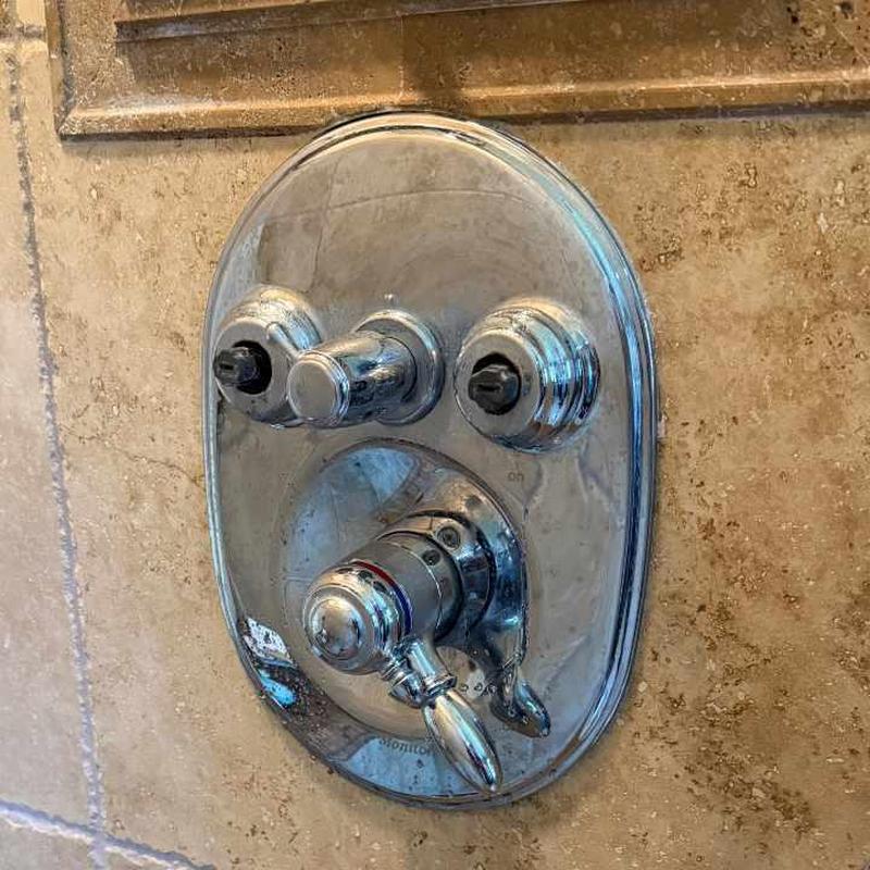 Delta shower valve stem and control panel in bathroom