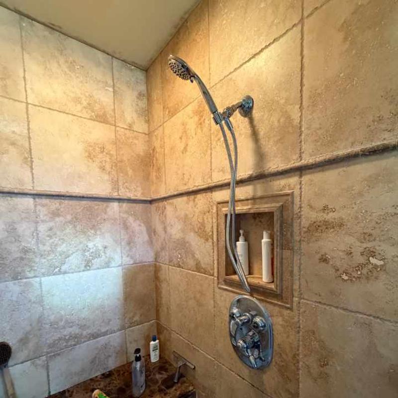 Delta shower stem and shower head in tiled shower