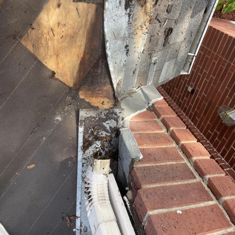 Chimney flashing and gutter downspout damage repair