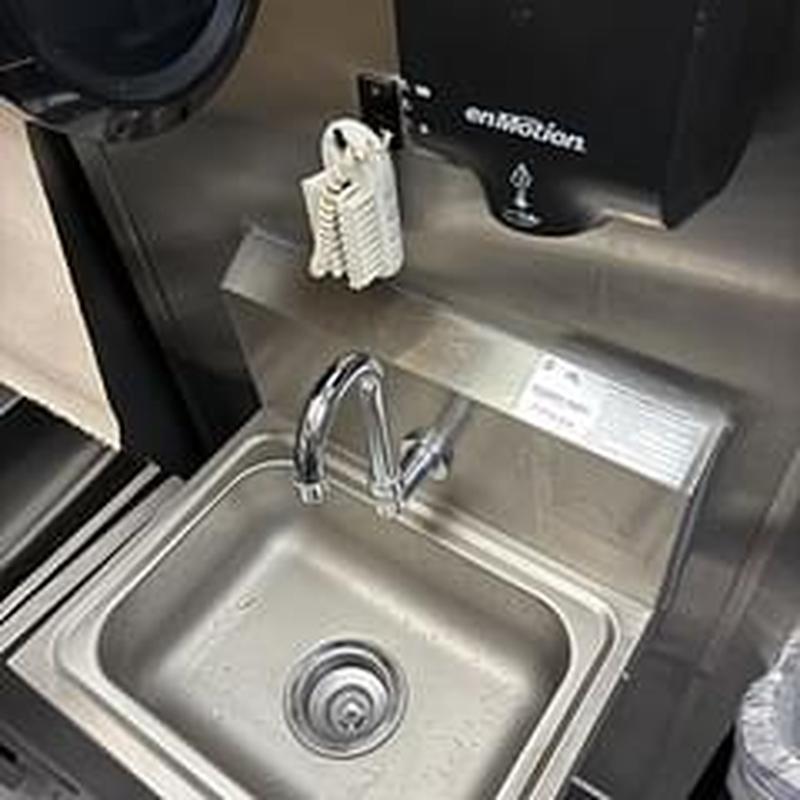 Hand sink faucet with relocated hot water tie-in