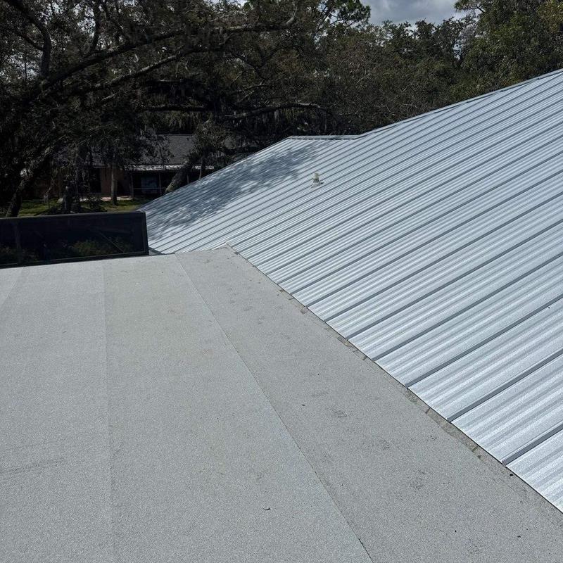 Standing seam metal roof with modified bitumen flat roof Standing seam metal roof with modified bitumen flat roof