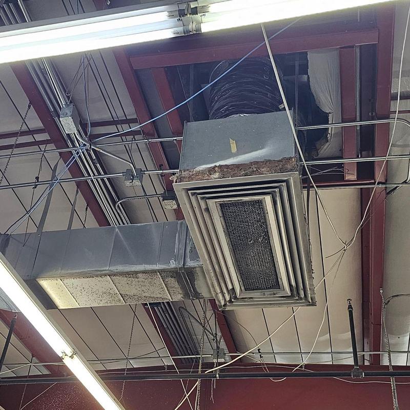 HVAC duct vent installation in warehouse ceiling
