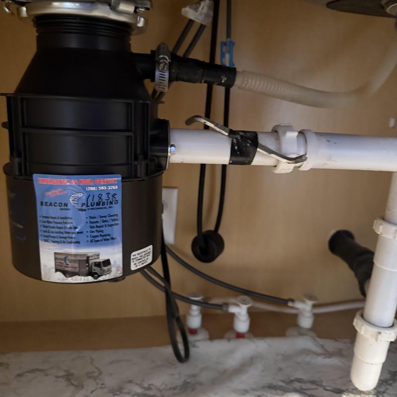 Garbage disposal with clogged screw under sink pipe