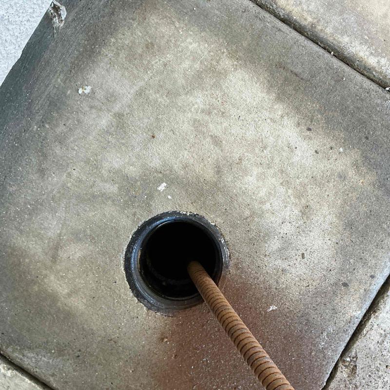 Main sewer line with plumbing snake clearing blockage