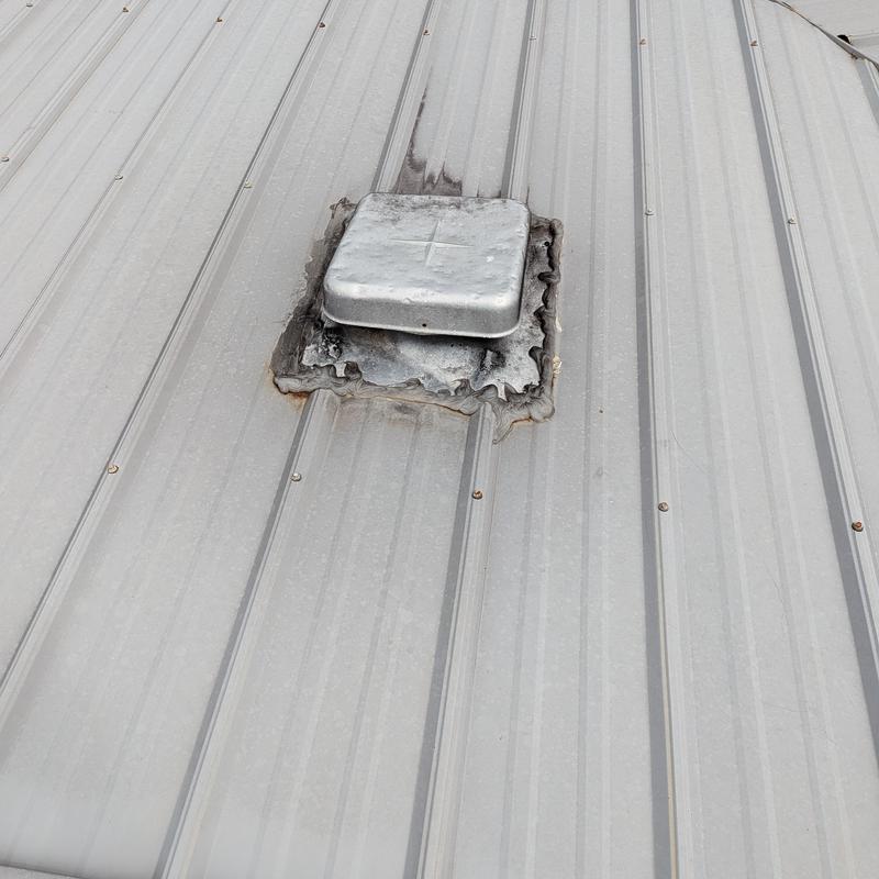 Metal roof vent with poor seal and corrosion signs Metal roof vent with poor seal and corrosion signs