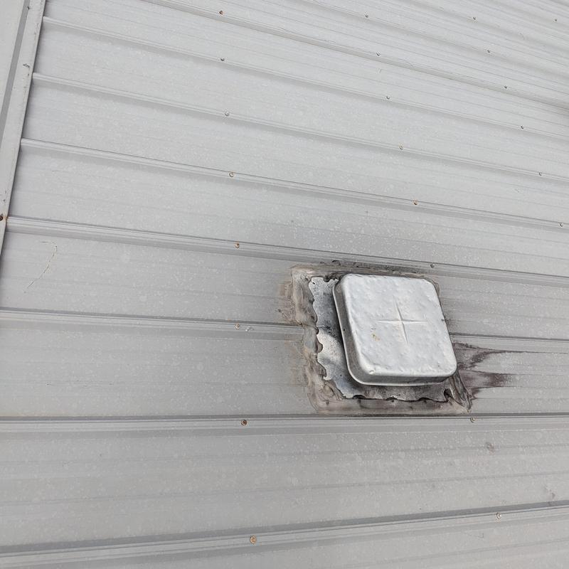 Metal roof vent with damaged sealant and surrounding rust Metal roof vent with damaged sealant and surrounding rust