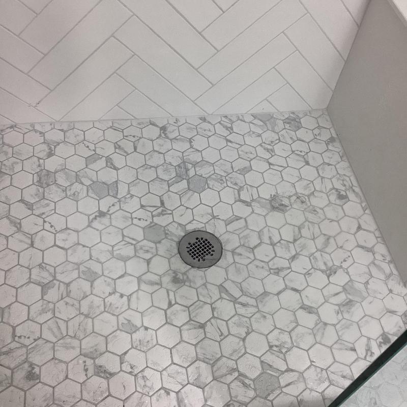 Bathroom shower drain with hex tile flooring