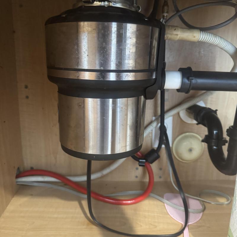 Garbage disposal installation under kitchen sink