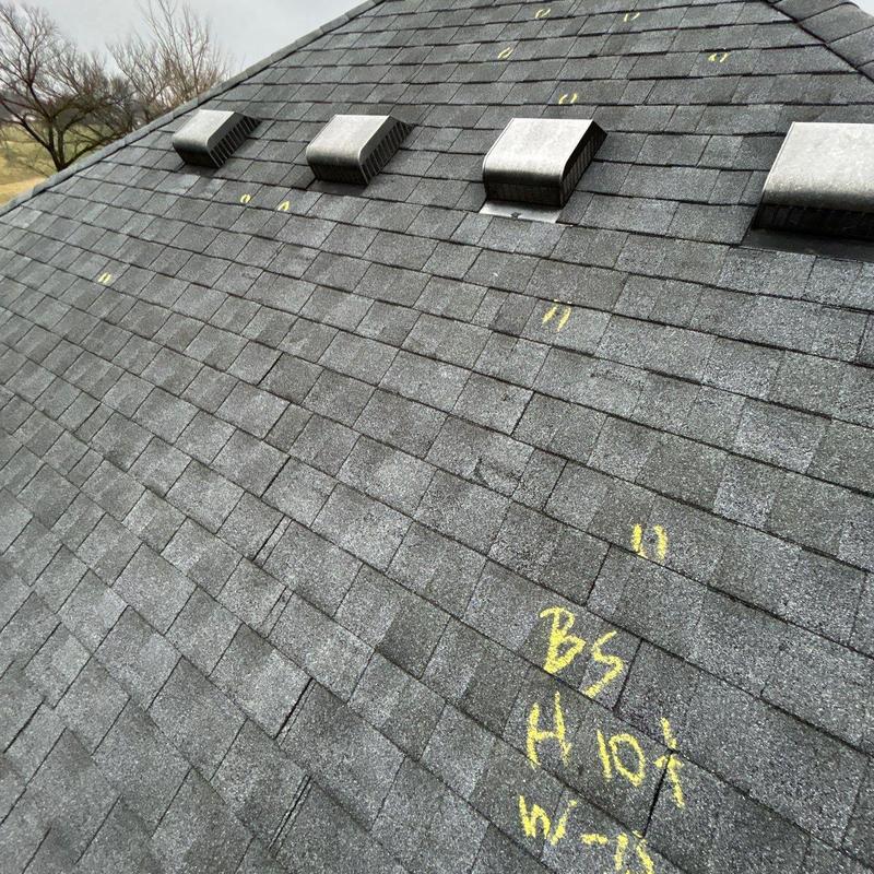 Asphalt roof shingles with hail damage markings