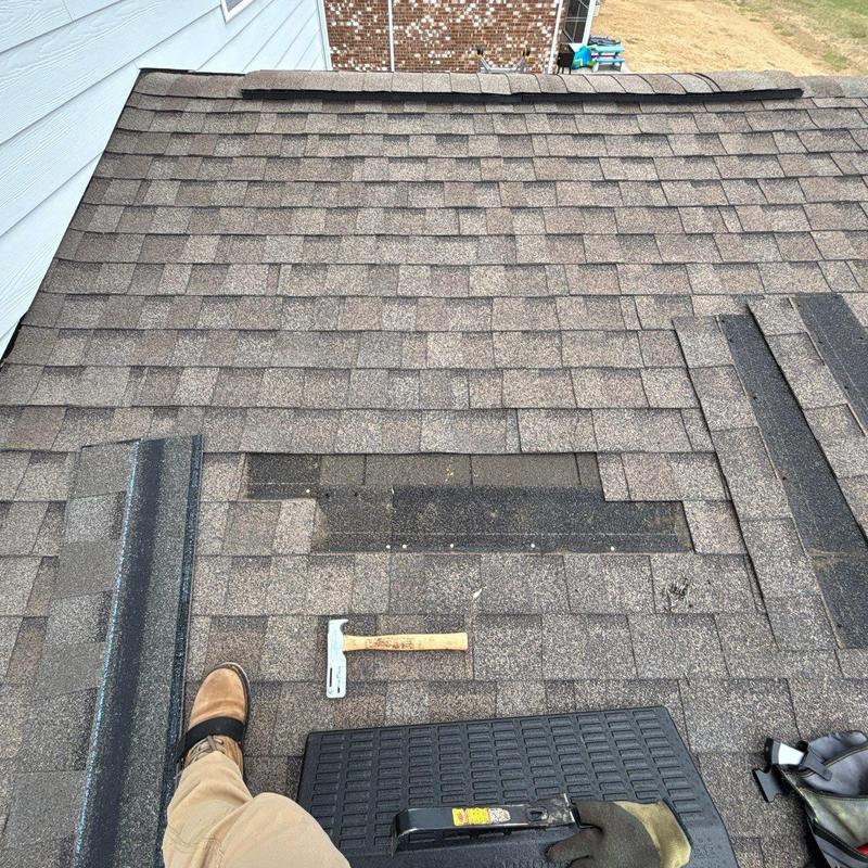 Asphalt shingle roof with replacement shingles and tools