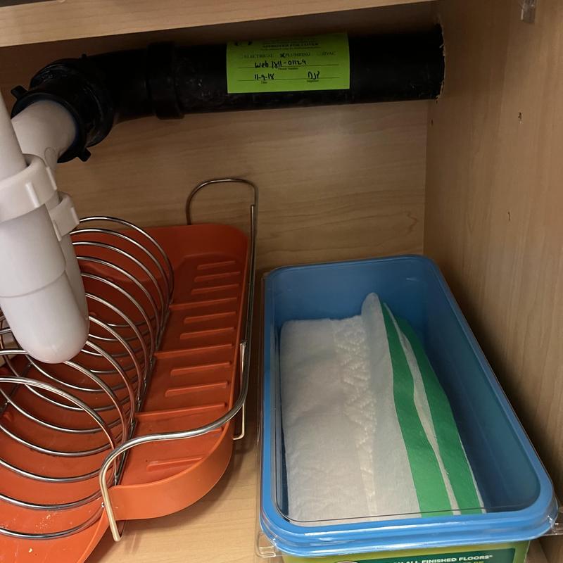 P-trap and drain pipe under kitchen sink in cabinet