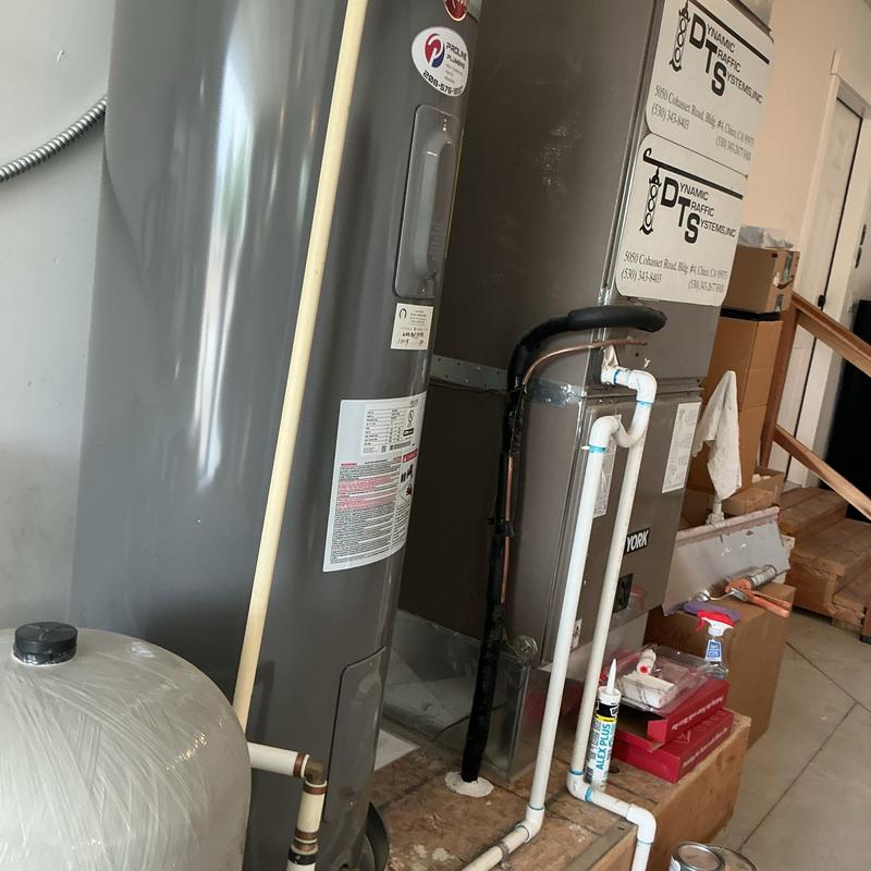 Water heater and HVAC system with PVC piping in utility room
