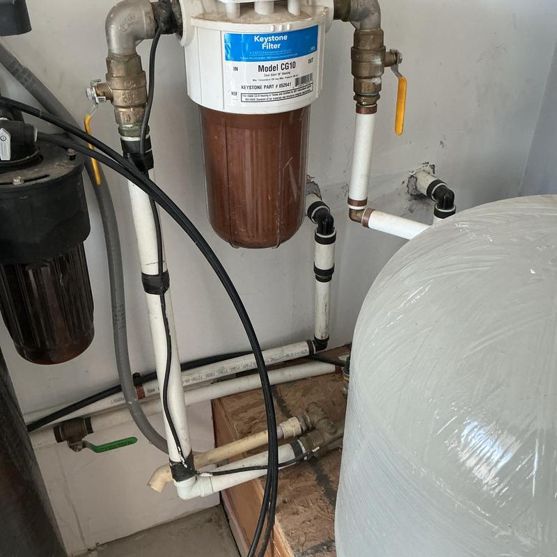 Water softener filter housing and plumbing connections