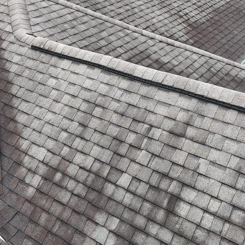 Roof shingles with hail damage on residential roof