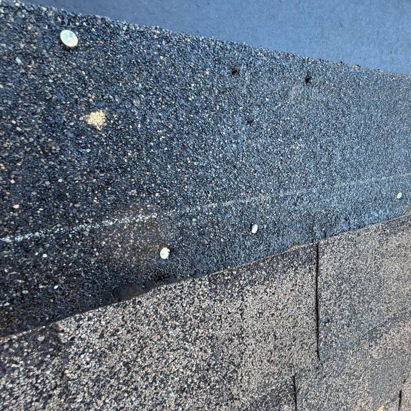 Asphalt roofing shingles with hail damage and nail heads