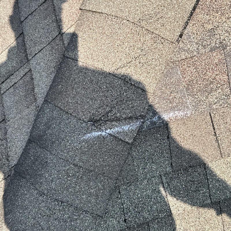 Asphalt shingle roof hail damage close-up with markings Asphalt shingle roof hail damage close-up with markings
