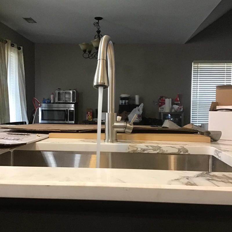 Kitchen sink faucet with running water in remodel