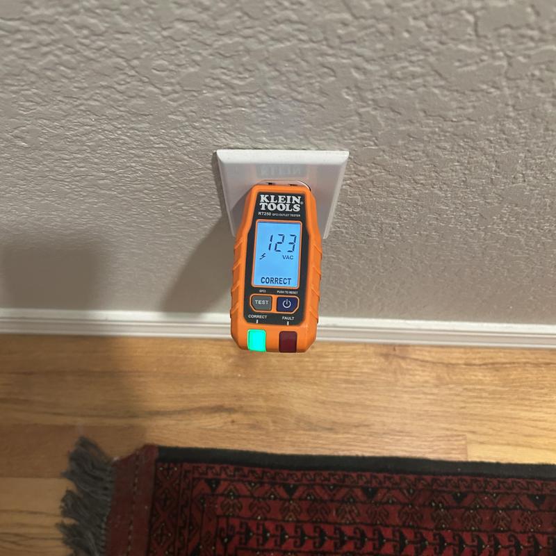 Outlet tester plugged into electrical receptacle