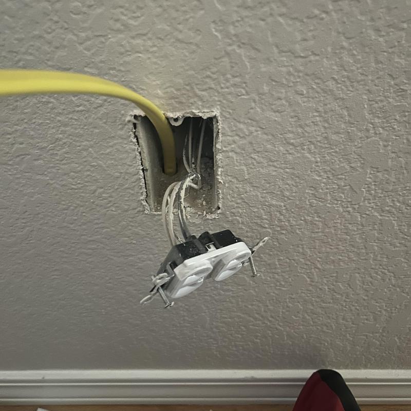 120V electrical outlet wiring with yellow cable in wall