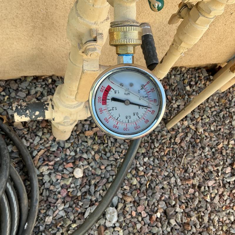 Water pressure gauge on outdoor hose bib setup