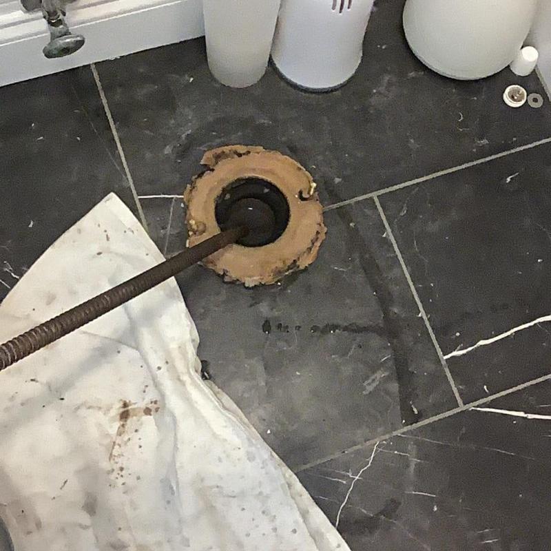 Toilet flange and drain line clearing with snake tool