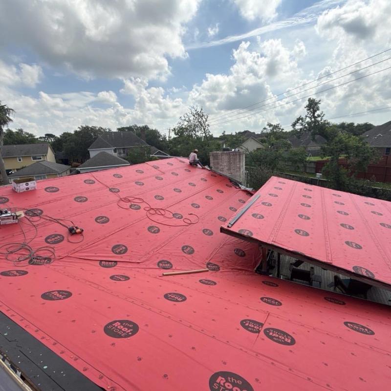 Synthetic roofing underlayment installation on residential roof