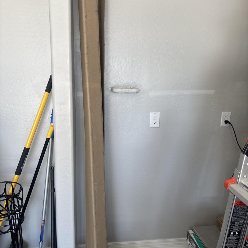 Water softener installation area with tools and ladder