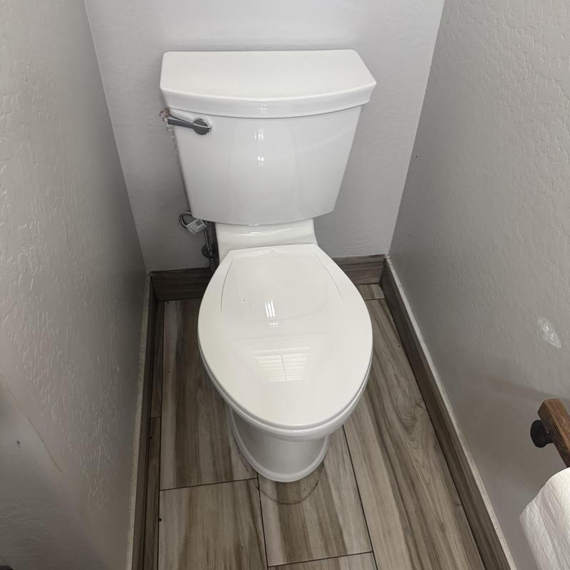 American Standard toilet installed in bathroom corner