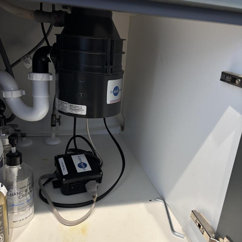 Garbage disposal with bone fragment removal under sink