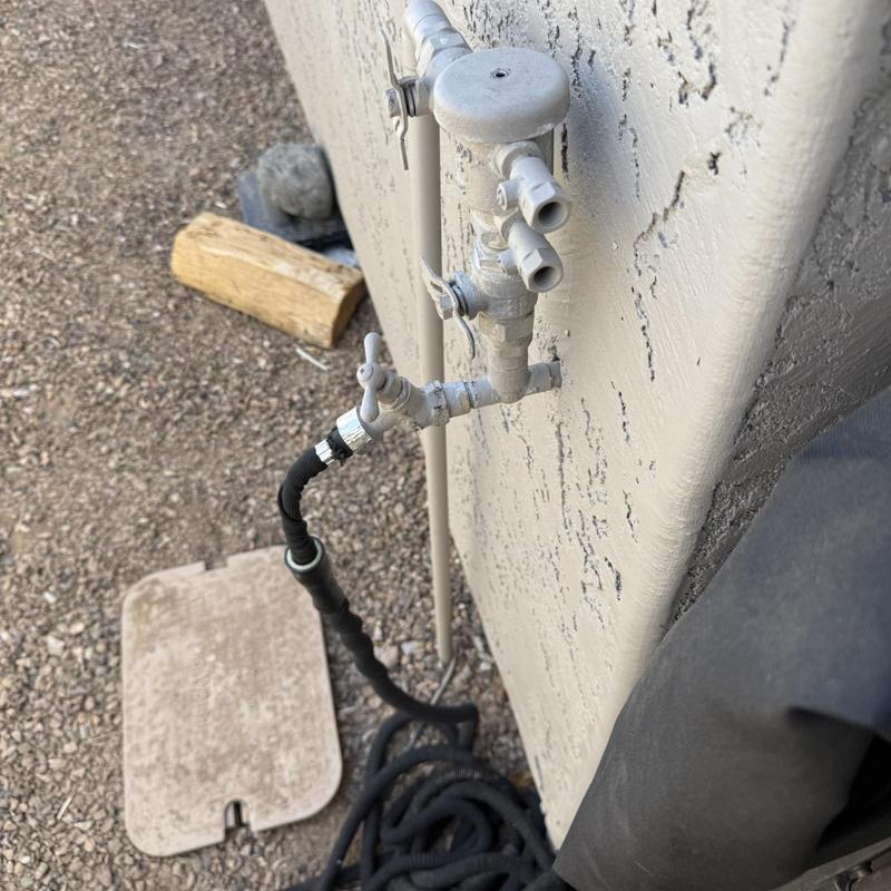 Outdoor hose bib with attached black expandable hose