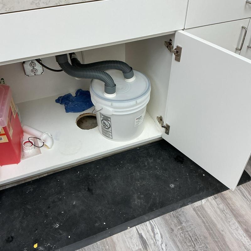 Air admittance valve under sink with wall hole nearby