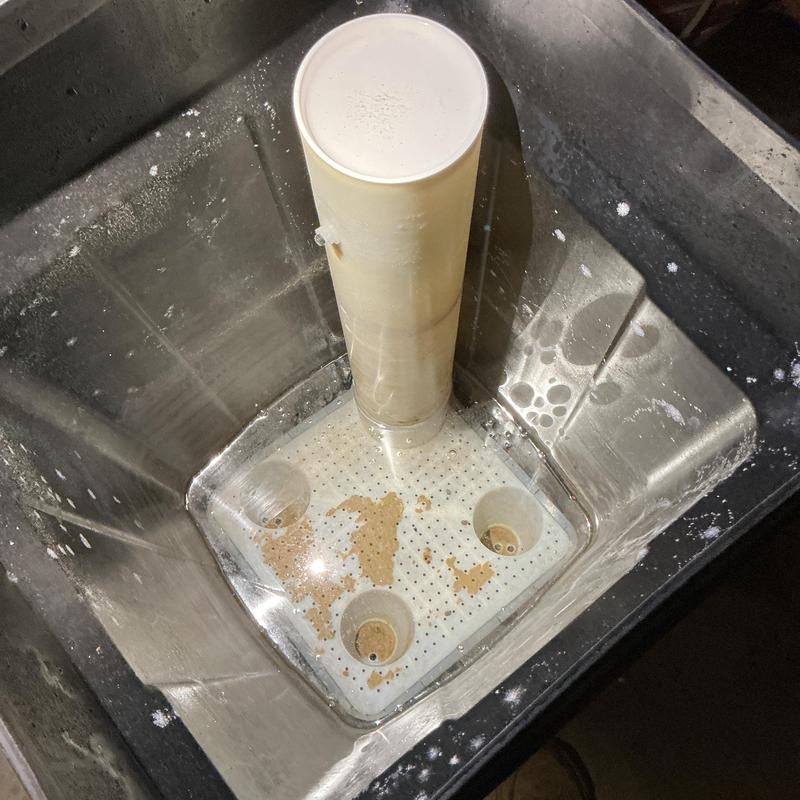 Sump pump basin with sediment buildup inside