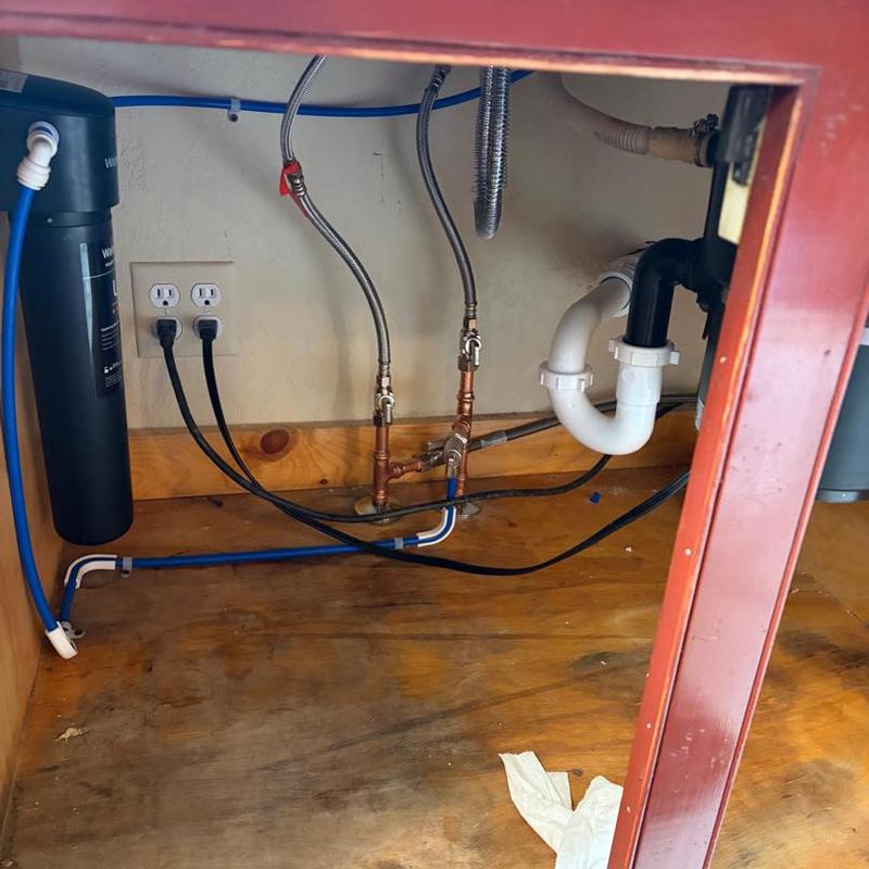 Water filtration system installation under kitchen sink