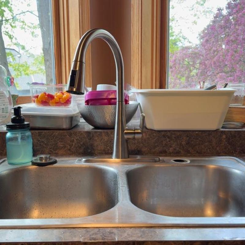 Kitchen faucet and shutoff valve near window sink