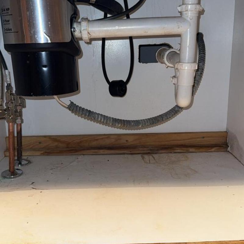 Kitchen sink plumbing with garbage disposal and pipes