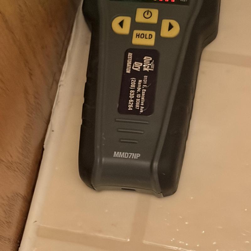 Toilet base with leak detection device placed