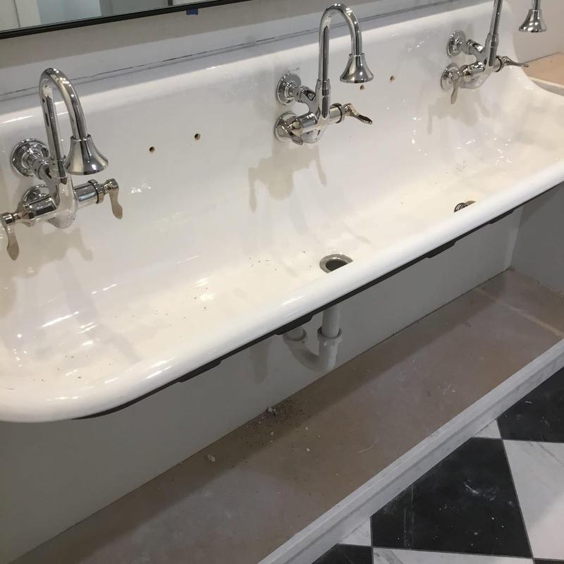 Wall-mounted sink with chrome faucets installation site