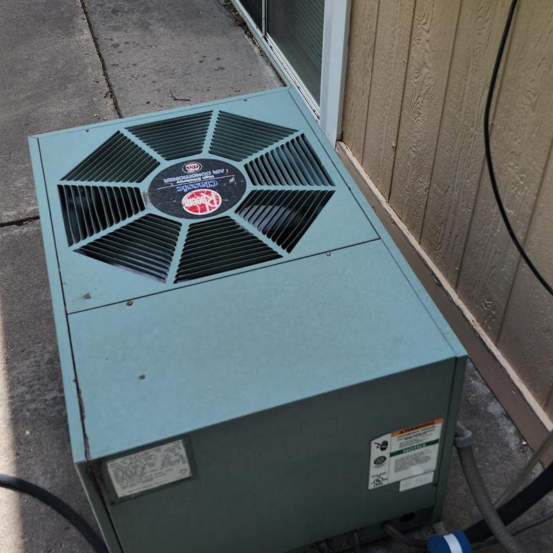 Rheem Classic air conditioner unit outside house