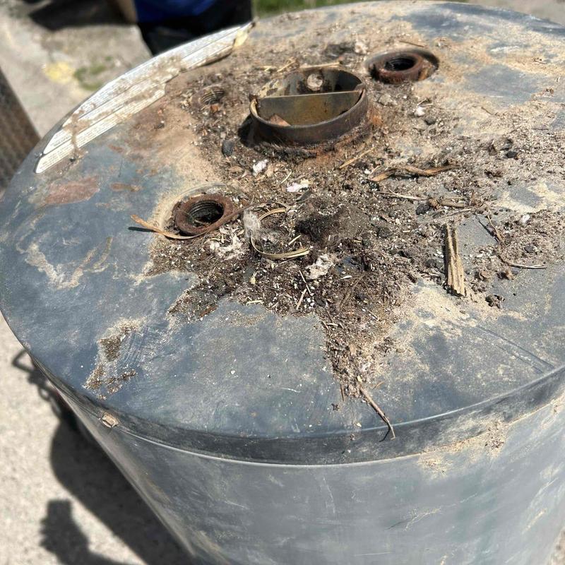 Water heater top with rust and debris buildup