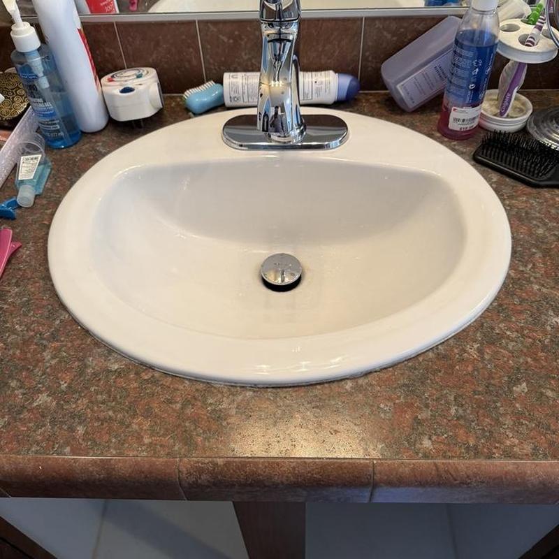 One-piece lavatory faucet with pop-up drain installed