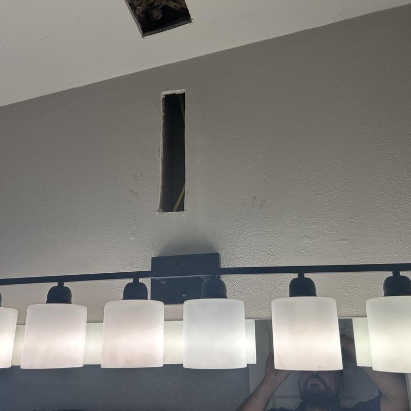 Bathroom exhaust fan sheetrock cutout above vanity light