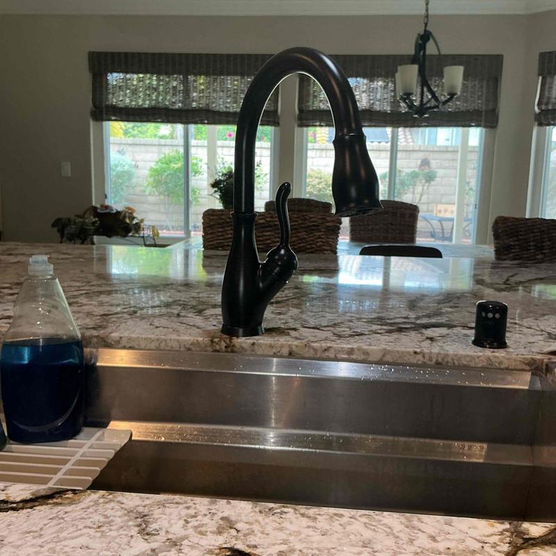 Kitchen faucet with pull-down sprayer on granite counter