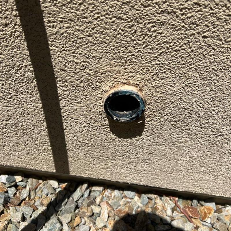 Kitchen drain exterior clean-out pipe opening on stucco wall Kitchen drain exterior clean-out pipe opening on stucco wall