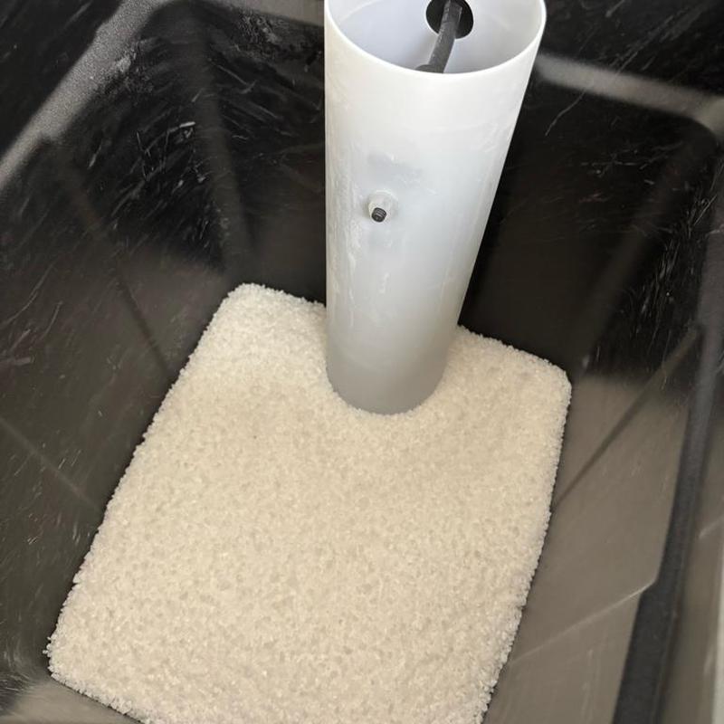 Water softener brine tank filled with salt pellets Water softener brine tank filled with salt pellets