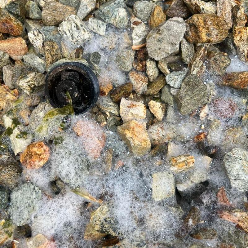 Exterior drain clean-out with foaming water and debris
