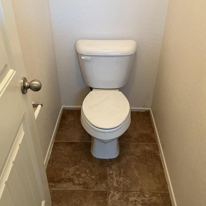 Primary bathroom toilet reinstalled in narrow space
