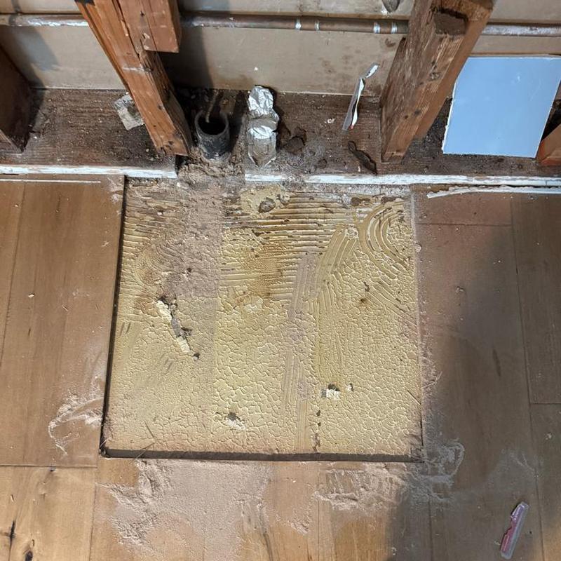 Cast iron drain pipe exposed with partial floor removed Cast iron drain pipe exposed with partial floor removed