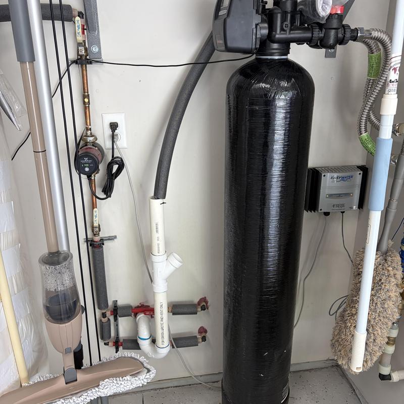 Iron filter system with connected pipes in garage