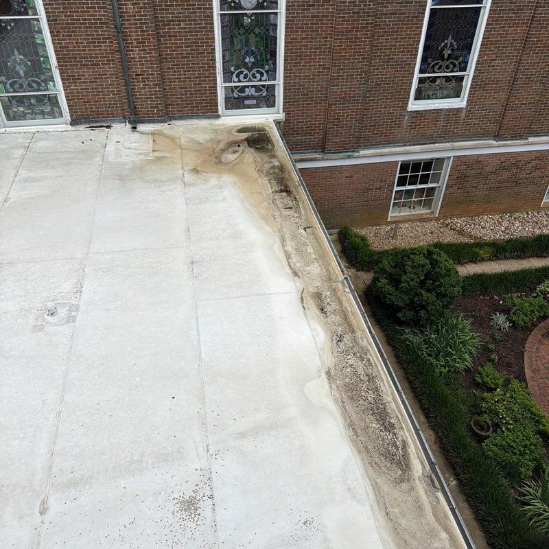 PVC flat roof with ponding water near gutter edge